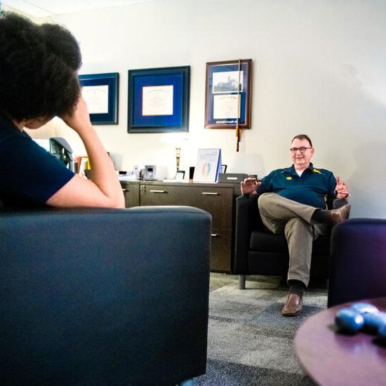 Two people chatting in a comfortable room.